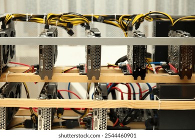 a home-based cryptocurrency mining farm, featuring multiple video cards arranged for efficient mining operations. The setup includes high-performance GPUs, wires, and cooling systems.