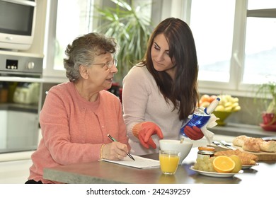 Homecare Helping Elderly Woman Doing Crossword