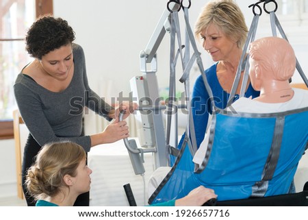 homecare nurses learning to use a hoist