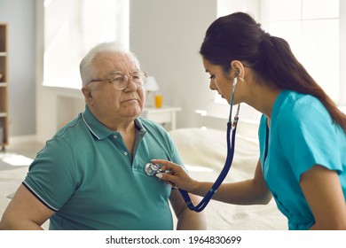 Homecare nursing service and elderly people cardiology healthcare. Close up of young hispanic female doctor nurse check mature caucasian man patient heartbeat using stethoscope during visit - Powered by Shutterstock