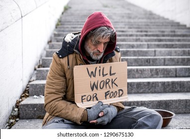 Homeless Beggar Man Sitting Outdoors In City Asking For Money Donation.