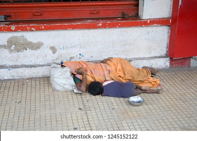 Homeless Beggars Mother And Child Sleeping On The Road