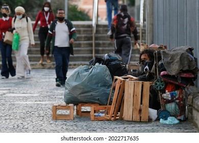 Homeless man, beggar living on a sidewalk during economic crisis at downtown, seeking help, hungry. Poverty vulnerable situation, social issues in latin america - Rio de Janeiro, Brazil 07.29.2021