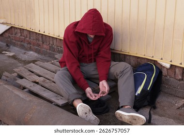 Homeless man counting coins on city street - Powered by Shutterstock - Get 15% off with code: PIKWIZARD15