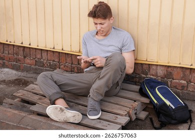 Homeless man counting coins on city street