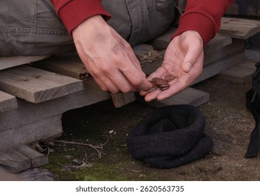 Homeless man counting coins outdoors, closeup view