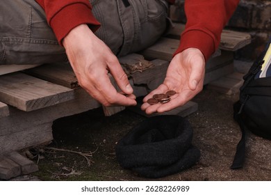 Homeless man counting coins outdoors, closeup view - Powered by Shutterstock - Get 15% off with code: PIKWIZARD15