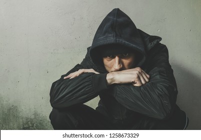 Homeless Man Drug And Alcohol Addict Sitting Alone And Depressed On The Street In Winter Clothes Feeling Anxious Cold And Lonely, Social Documentary Concept Dramatic Image