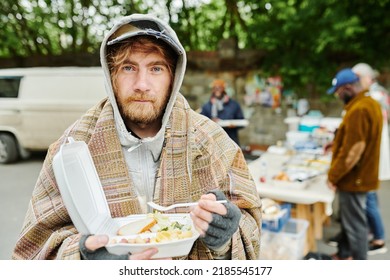 Homeless man eating food outdoors