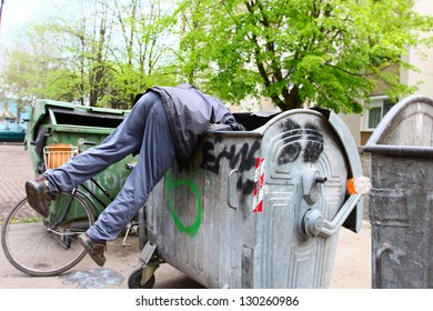 A Homeless Man Looking For Food In A Garbage Dumpster. / Urban Poverty