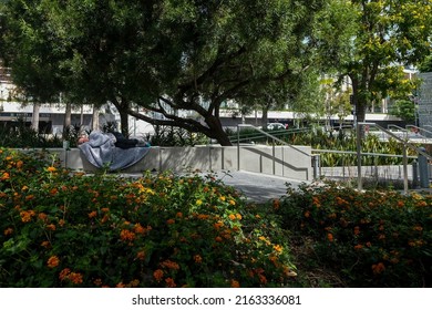 A homeless man rests at the Grand Park in downtown Los Angeles, June 2, 2022. 