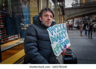 Homeless Man With Sign Peddles Outside Grand Central Station, NYC. December 2019