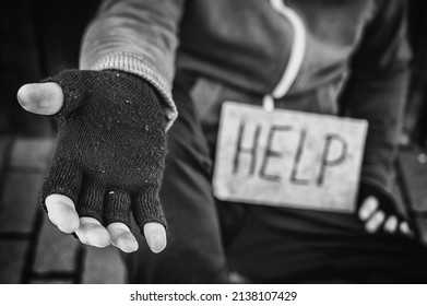 Homeless Man Sits On The Street Begging For Help