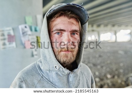 Homeless man in torn clothes