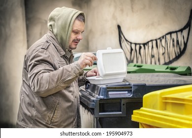 Homeless Near Garbage Container With Food Box 