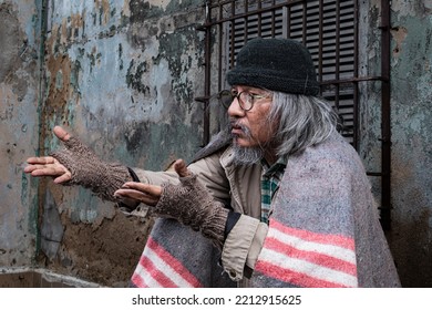 Homeless Old Man Reaching Out To Passerby Ask For Money, Need For Help, Poverty Man No Home Meet Financial Crisis Ask For Food Live On Sidewalk. Donate And Charity Concept.