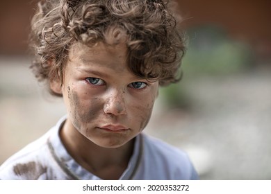 A Homeless Orphan Boy Looks With Eyes Full Of Tears