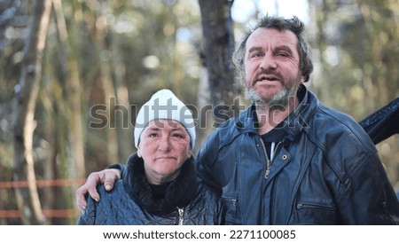 Homeless people are interviewed in the winter in the woods.