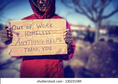 a homeless person with a sign