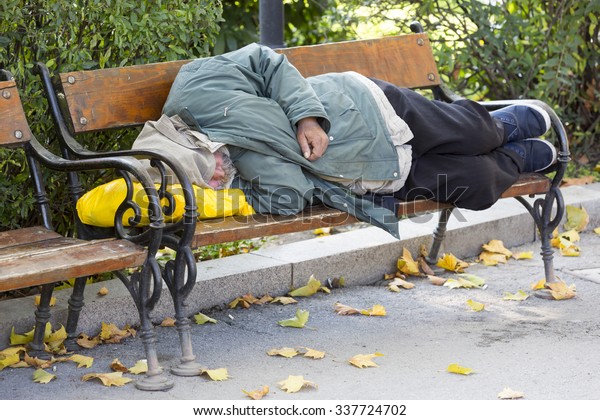 Homeless\
person is sleeping on a bench in a cold autumn day in a park in\
European union\'s poorest country\
Bulgaria.