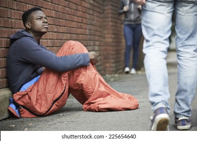 Homeless Teenage Boy In Sleeping Bag On The Street