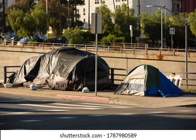 A homeless tent encampment occupies a Downtown Los Angeles Street.