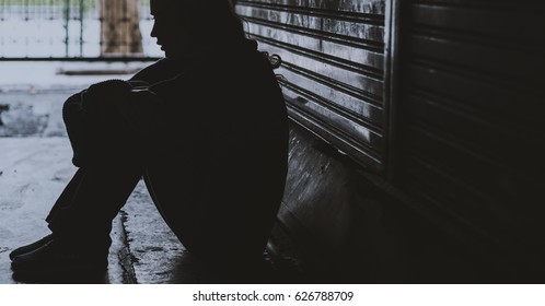 Homeless Woman Sitting on The Street Side Hopeless