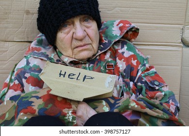 Homeless Women Sitting On A Street