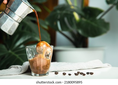 homemade Affogato, Italian Moka coffee pot, affogato is dessert with coffee as base ingredient typically scooping a scoop of gelato or vanilla ice cream into a cup. Then pour one shot of hot espresso. - Shutterstock ID 2180095895