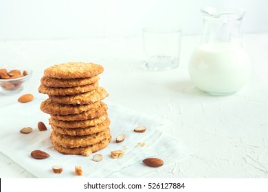 Homemade almond cookies on white table with copy space - healthy homemade vegan vegetarian pastry with almonds nuts