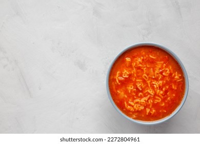 Homemade Alphabet Soup in Tomato Sauce in a Bowl, top view. Overhead, from above, flat lay. Copy space.