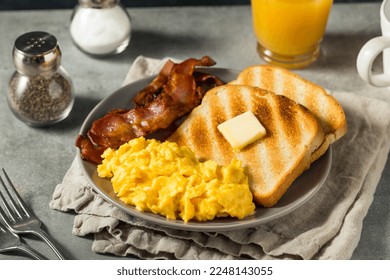Homemade American Scrambled Egg Breakfast with Bacon and Toast