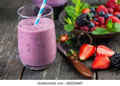Homemade antioxidant summer fruits smoothie on rustic table