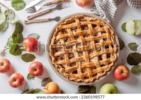 Homemade Apple Pie with fresh apples on white kitchen table, top view, flat lay. Thanksgiving traditional dessert, Thanksgiving tart preparation, autumn bakery. Crispy weather sweets. Recipe