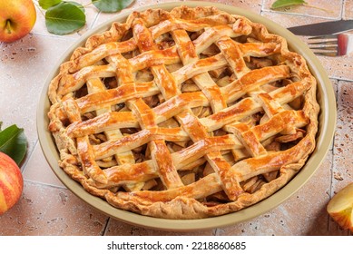 Homemade Apple Pie with fresh red apple and leaves on beige travertine tiles table background, top view, flat lay Classic autumn Thanksgiving dessert apple pie, close up - Shutterstock ID 2218860685
