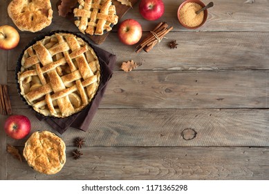 Homemade Apple Pies On Rustic Background, Top View, Copy Space. Classic Autumn Thanksgiving Dessert - Organic Apple Pie.