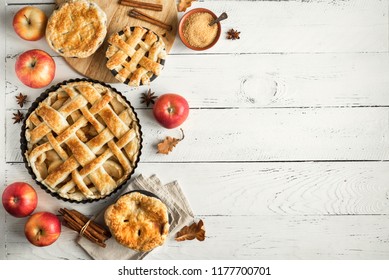 Homemade Apple Pies On White Wooden Background, Top View. Classic Autumn Thanksgiving Dessert - Organic Apple Pie.