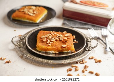Homemade arabian traditional sweets Kunafa with Nuts and honey syrup soft kunafa, konafa

                      