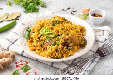 Homemade arabic chicken biryani on a plate. Indian food. Spicy chicken with rice close-up.