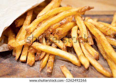 Homemade authentic healthy oil free fresh delicious golden real organic potato french fries wedges with natural skins with salt, pepper, mayonnaise, ketchup sauce. Tasty vegetarian appetizer meal