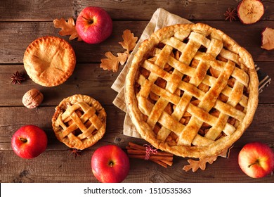 Homemade autumn apple pies, top view table scene with a rustic wood background