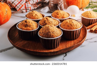Homemade autumn pumpkin muffin with chia seeds on white marble background. Selectve focus