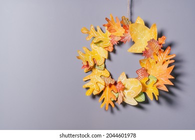 Homemade autumn yellow-red paper wreath on a gray wall background. Seasonal DIY - Powered by Shutterstock