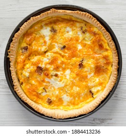 Homemade Bacon Quiche With Eggs And Cheddar Cheese On A White Wooden Background, Overhead View. Flat Lay, From Above, Top View. Close-up.