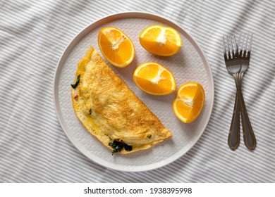 Homemade Bacon Spinach Omelette With Cheddar Cheese, Overhead View. Flat Lay, Top View, From Above. 