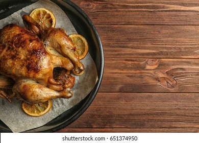 Homemade Baked Chicken With Lemon On Wooden Table