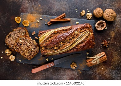 Homemade banana bread with walnut and cinnamon on a stone background