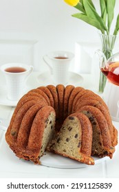 Homemade Banana Bundt Cake Slice On White Table, Served With Tea For Afternoon Tea