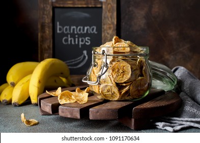 Homemade banana chips in a glass jar. Banana dessert