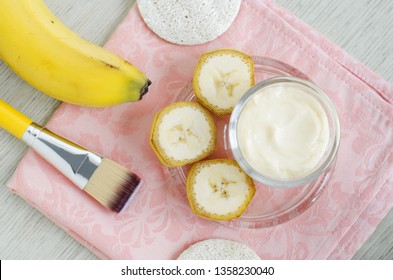 Homemade Banana Face Mask (moisturizer) In The Small Glass Jar And Cosmetic Brush. DIY Beauty Treatments And Spa. Top View, Copy Space.